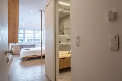 a room with a bed and a room with a door at Luxurious Studio in the Heart of Athens in Athens