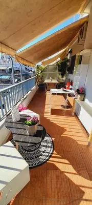 a balcony on a cruise ship with a table and flowers at v&k apartment in Athens