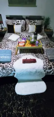 a bed with towels and a tray on top of it at v&k apartment in Athens