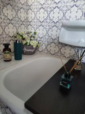 a white bathroom sink with flowers on top of it at v&k apartment in Athens