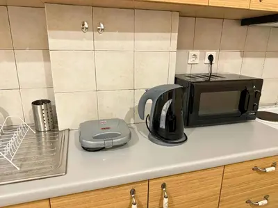 a kitchen counter with a microwave and a toaster at Apartment Next to the Metro 100m in Athens