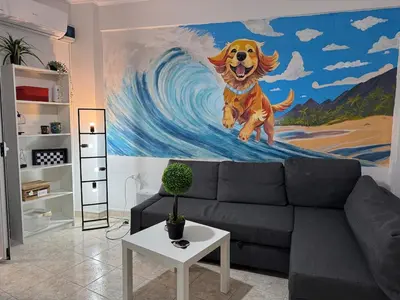 a painting of a dog on a wave in a living room at Apartment Next to the Metro 100m in Athens