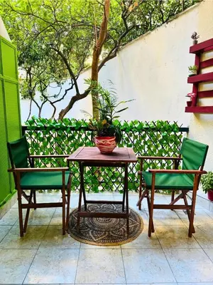a table and two chairs and a table with a plant at Apartment Next to the Metro 100m in Athens