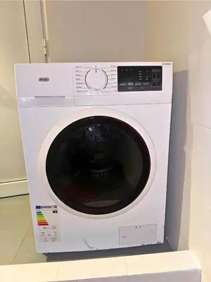 a white washing machine sitting in a room at Apartment Next to the Metro 100m in Athens