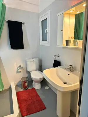 a bathroom with a white toilet and a sink at Apartment Next to the Metro 100m in Athens