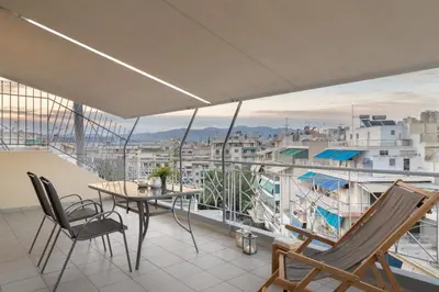a balcony with a table and chairs and a view at Large terrace studio in Athens