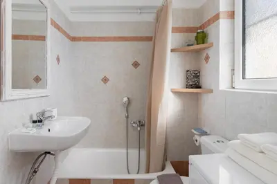 a bathroom with a shower and a sink and a toilet at Large terrace studio in Athens