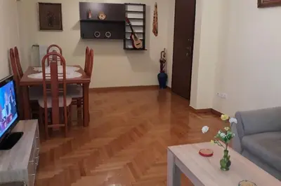 a living room with a couch and a dining room at Cozy and spacious 2 BDR Apt 15 min from the city center in Athens