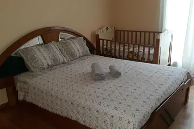 a bedroom with a bed with shoes on it at Cozy and spacious 2 BDR Apt 15 min from the city center in Athens