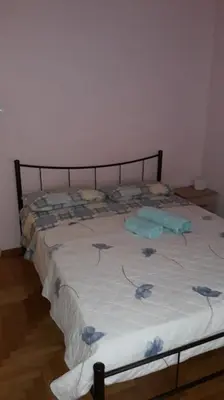 a bed with blue flowers on it in a room at Cozy and spacious 2 BDR Apt 15 min from the city center in Athens