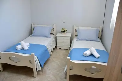 a bedroom with two beds with towels on them at Kathrine's Cottage in Vagia in Vaia