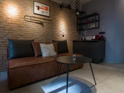 a living room with a couch and a table at City Plus by CityBee in Athens