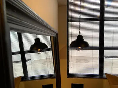 two windows in a room with two lights at City Plus by CityBee in Athens