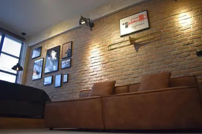 a room with a brick wall with a couch at City Plus by CityBee in Athens
