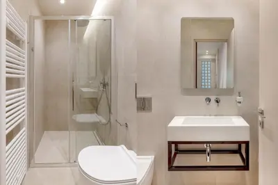 a bathroom with a sink and a toilet and a shower at Culture Retreat Apartments near Archaeological Museum by Upstreet in Athens