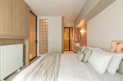 a bedroom with a large white bed with white pillows at Culture Retreat Apartments near Archaeological Museum by Upstreet in Athens