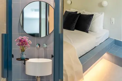 a bedroom with a bed with a mirror at Culture Retreat Apartments near Archaeological Museum by Upstreet in Athens