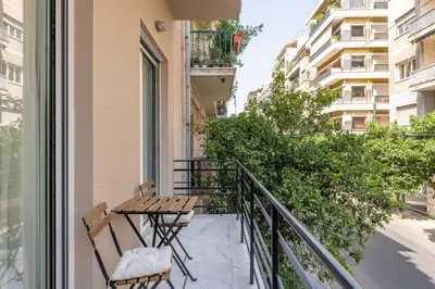 a balcony with a table and chairs on a building at Culture Retreat Apartments near Archaeological Museum by Upstreet in Athens