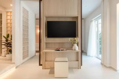 a living room with a tv on a wall at Culture Retreat Apartments near Archaeological Museum by Upstreet in Athens