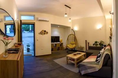 a living room with a couch and a table at Kastella Bohemian Pied a Terre in Piraeus