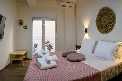a bedroom with a large bed with stuffed animals on it at Kastella Bohemian Pied a Terre in Piraeus