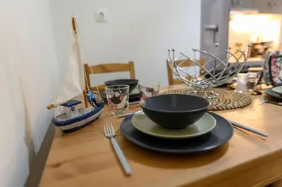 a wooden table with a bowl and a plate on it at Kastella Bohemian Pied a Terre in Piraeus