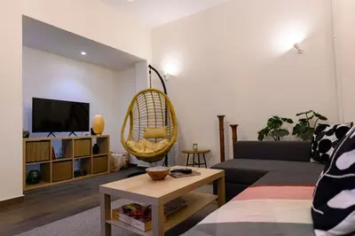 a living room with a couch and a chair at Kastella Bohemian Pied a Terre in Piraeus