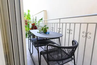 a small table and two chairs on a balcony at Kastella Bohemian Pied a Terre in Piraeus