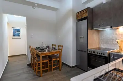 a kitchen with a table and chairs in a room at Kastella Bohemian Pied a Terre in Piraeus