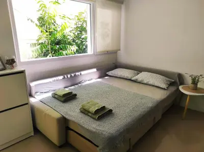 a bedroom with a bed with two towels on it at Viktoria's garden home in Athens