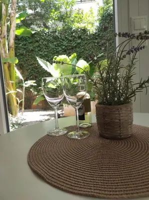 two wine glasses and a potted plant on a table at Viktoria's garden home in Athens
