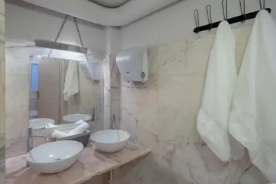 a bathroom with two sinks and two mirrors at Plastiko Loft in Athens