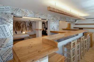a room with a bar with stools and a table at Plastiko Loft in Athens