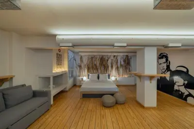 a living room with a bed and a couch at Plastiko Loft in Athens