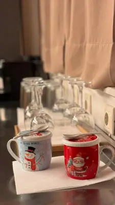 two coffee cups sitting on a counter next to a table at Plastiko Loft in Athens