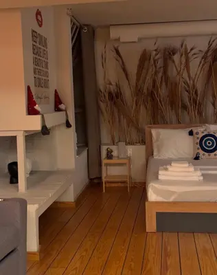 a bedroom with a bed and a wall with a painting at Plastiko Loft in Athens