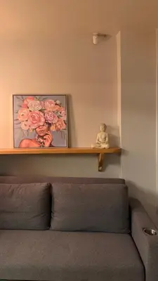 a shelf above a couch with a picture of roses at Plastiko Loft in Athens