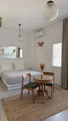 a bedroom with a table and a bed and a table and chair at Stylish Studio in Psyri in Athens
