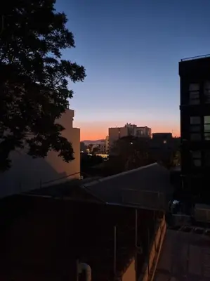 a view of a city at sunset from a building at Stylish Studio in Psyri in Athens