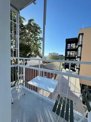 a balcony with two chairs and a table on it at Stylish Studio in Psyri in Athens