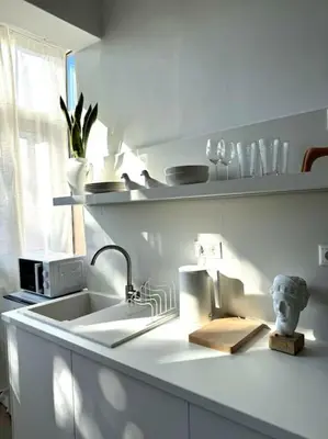 a kitchen counter with a sink and a window at Stylish Studio in Psyri in Athens