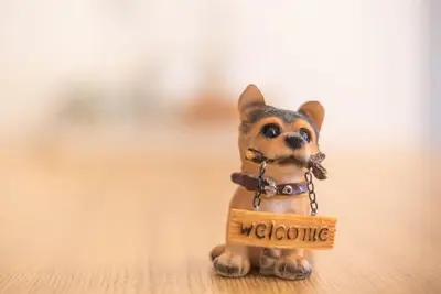 a small figurine of a dog with a welcome sign at Urban Αpartment in Athens