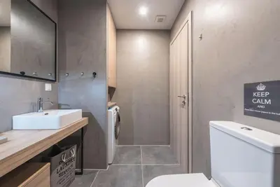 a bathroom with a white sink and a toilet at Urban Αpartment in Athens