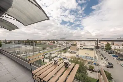 a bench sitting on top of a building with a street at Urban Αpartment in Athens