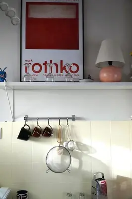 a shelf with pots and pans and a lamp at Cozy, central studio with expansive balcony in Athens