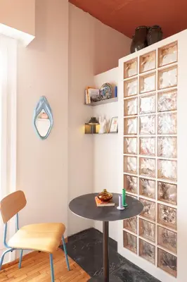 a table and a chair in a room at Cozy, central studio with expansive balcony in Athens