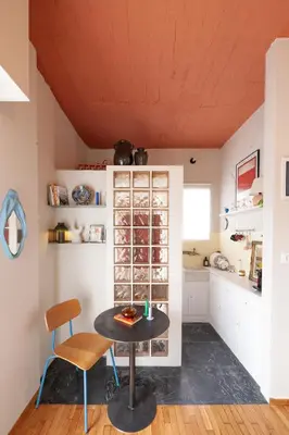 a kitchen with a table and chairs in a room at Cozy, central studio with expansive balcony in Athens