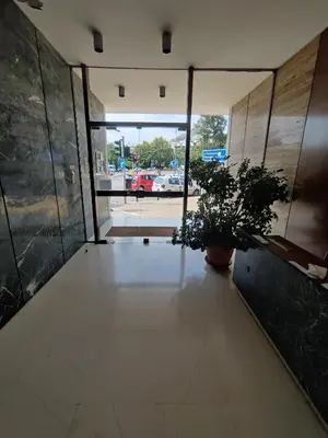 an empty room with two potted plants in a building at Pagkrati Apartment 80 in Athens