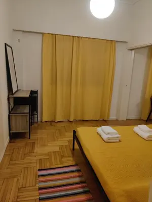 a room with two beds and a piano at Pagkrati Apartment 80 in Athens