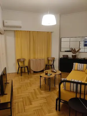 a living room with a couch and a table at Pagkrati Apartment 80 in Athens